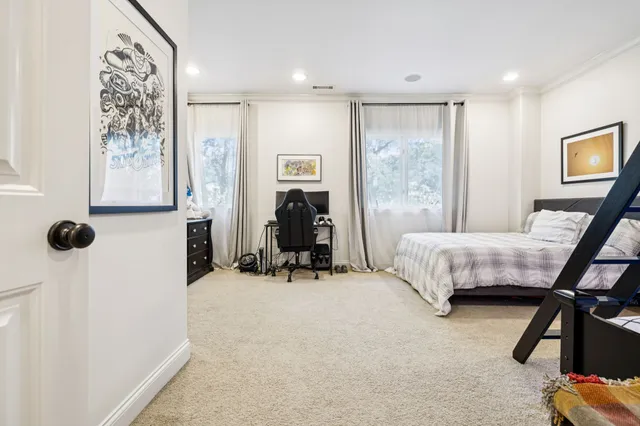 a spacious bedroom with a bed and a window