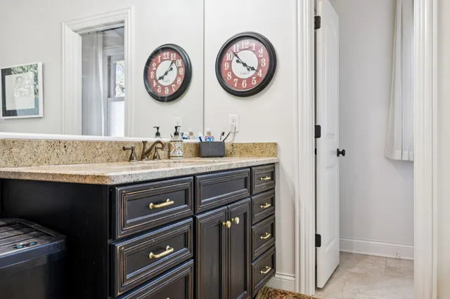 a bathroom with a granite countertop bathtub shower and toilet
