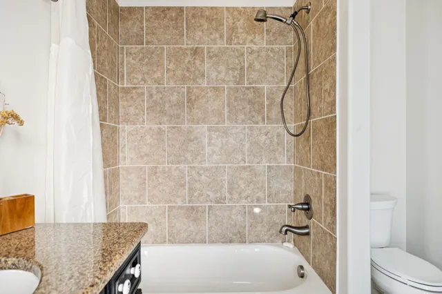 a bedroom with furniture and a chandelier