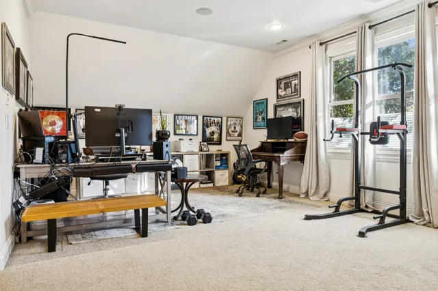 a backyard of a house with wooden floor chairs and wooden fence