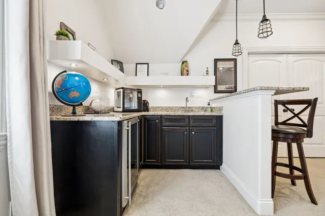 a view of a patio with table and chairs and wooden floor