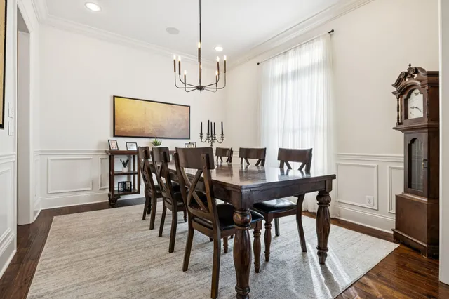 a view of a dining room with furniture and chandelier