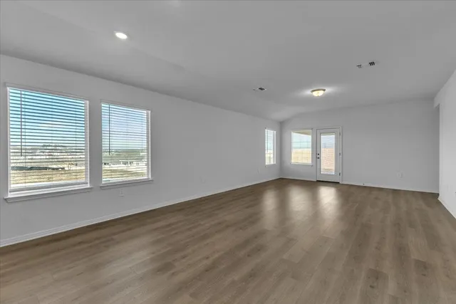 a kitchen with stainless steel appliances granite countertop a sink a stove and a wooden floors