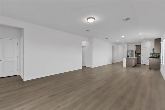 a view of a kitchen with a sink and a refrigerator