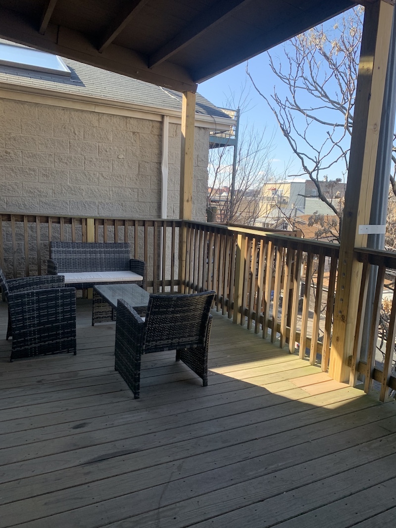 1740 West Huron Street, Unit 3F Chicago, IL 60622 - Photo 18 of 18 a roof deck with wooden floor and fence
