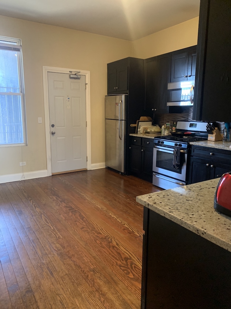1740 West Huron Street, Unit 3F Chicago, IL 60622 - Photo 9 of 18 a kitchen with granite countertop a refrigerator stove top oven and sink