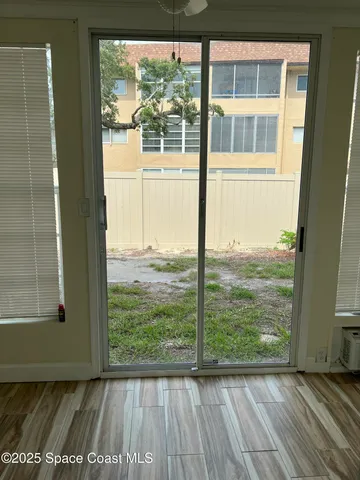 a view of a livingroom with wooden floor and a window