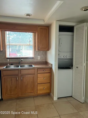 a kitchen with a refrigerator and a sink