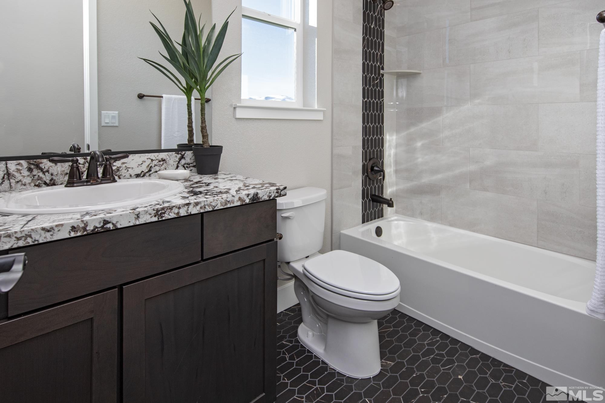 7719 Enclave Key Road Reno, NV 89506 - Photo 11 of 26 a bath room with a sink and a toilet