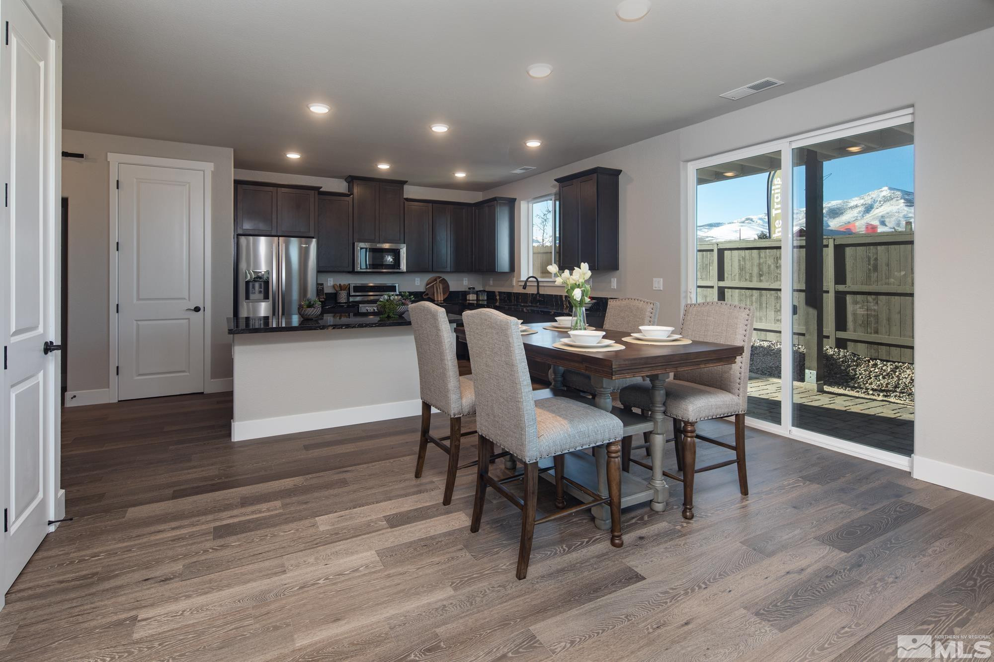 7719 Enclave Key Road Reno, NV 89506 - Photo 22 of 26 a view of a dining room with furniture and wooden floor