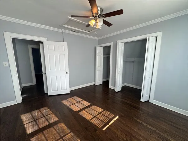 a view of empty room with wooden floor