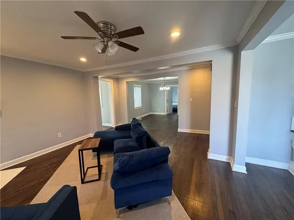 a living room with furniture and wooden floor
