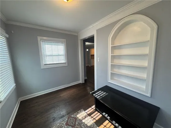 a living room with hard wood floors and a window