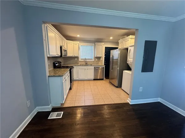 a kitchen with a sink and wooden cabinets