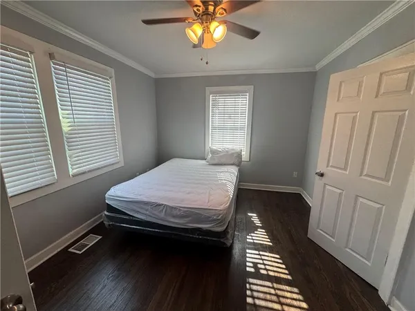 a bedroom with a bed table and a window