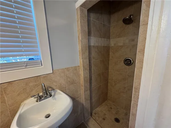 a bathroom with a shower and sink