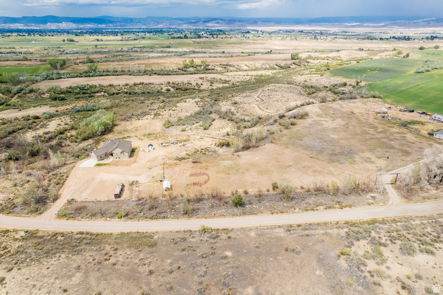 2101 Goose Ranch Road Vernal, UT 84078 - Photo 71 of 72 Expansive rural property featuring a single-story residence with a stone and stucco exterior, a gravel driveway, and a fenced perimeter