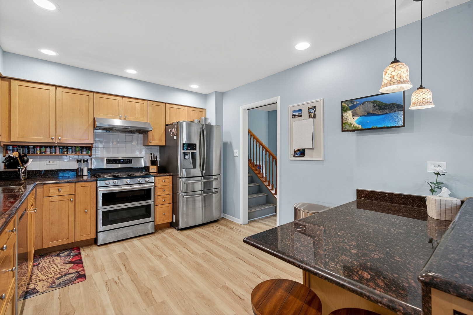 185 North Happ Road Northfield, IL 60093 - Photo 11 of 38 a kitchen with stainless steel appliances granite countertop a refrigerator and a stove top oven