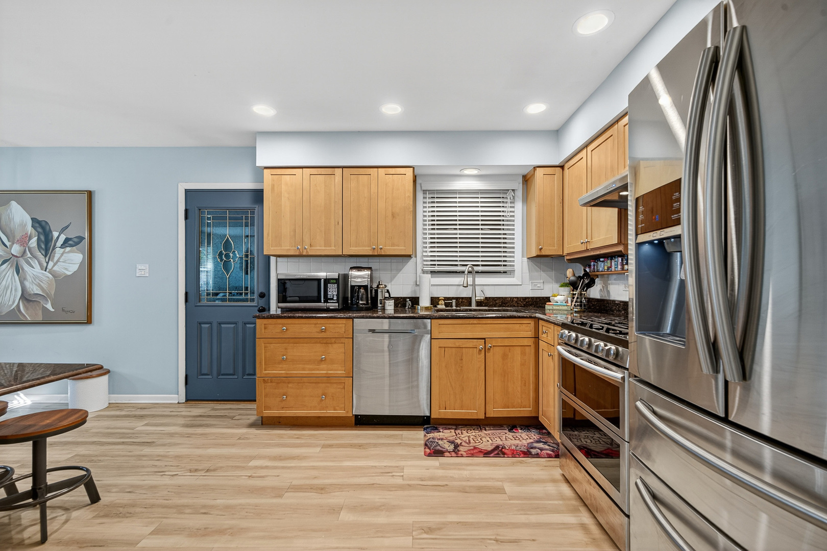 185 North Happ Road Northfield, IL 60093 - Photo 13 of 38 a kitchen with stainless steel appliances granite countertop a stove a sink and a refrigerator