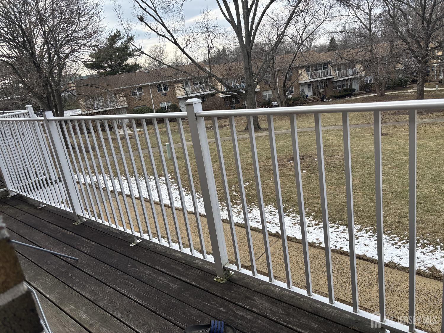 363 Cranbury Road, Unit A16 East Brunswick, NJ 08816 - Photo 12 of 12 a view of a roof deck with wooden fence and floor