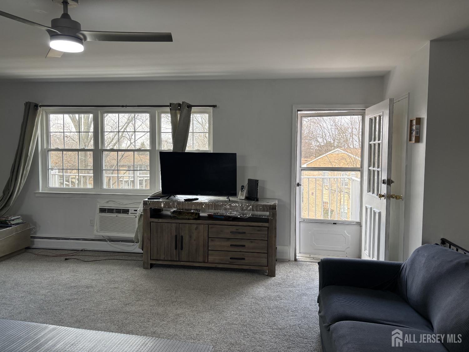 363 Cranbury Road, Unit A16 East Brunswick, NJ 08816 - Photo 6 of 12 a living room with furniture and a flat screen tv