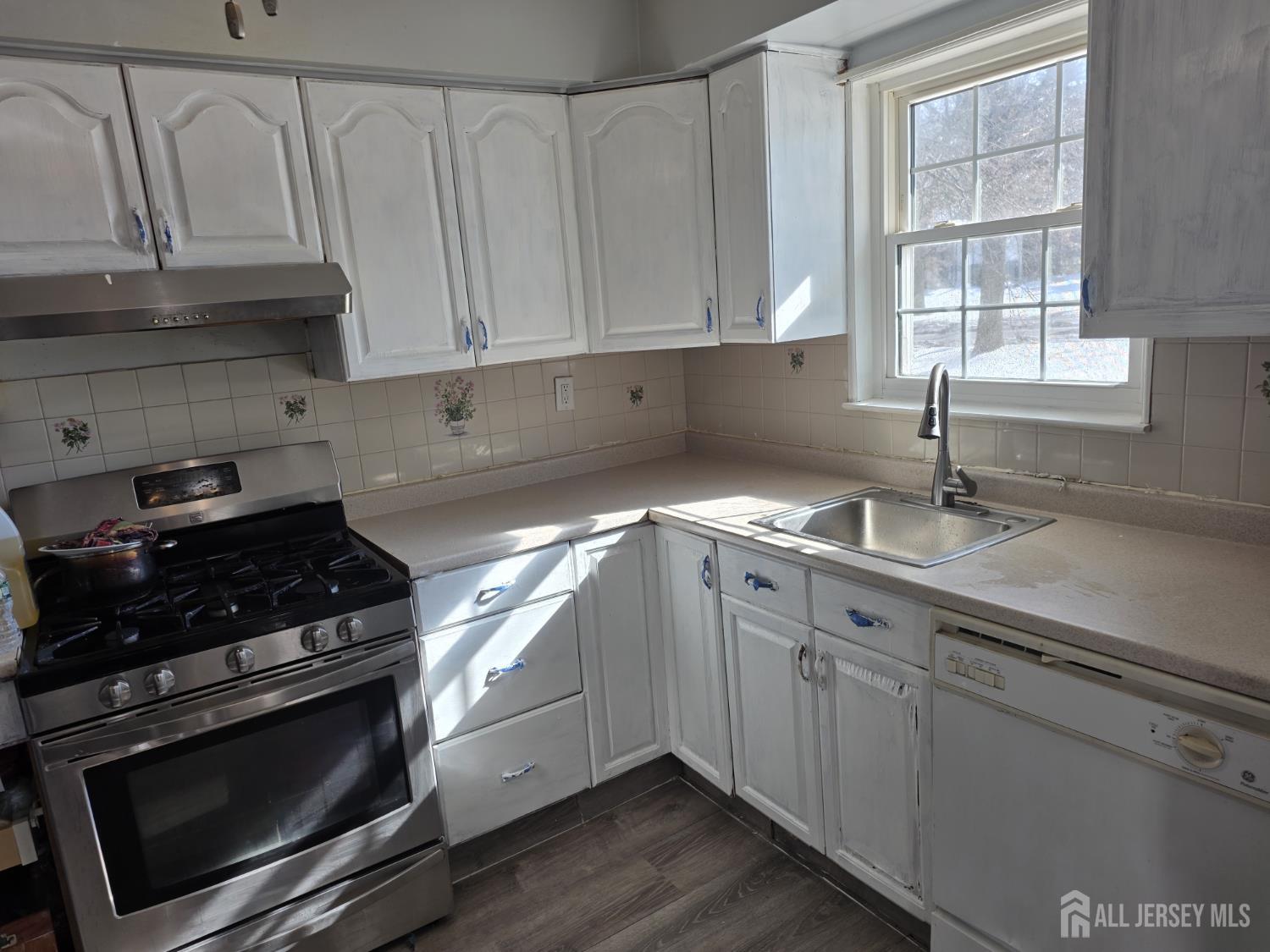 363 Cranbury Road, Unit A16 East Brunswick, NJ 08816 - Photo 8 of 12 a kitchen with granite countertop white cabinets stainless steel appliances and a sink