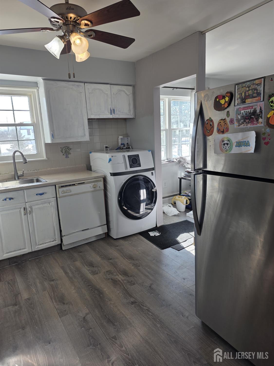363 Cranbury Road, Unit A16 East Brunswick, NJ 08816 - Photo 10 of 12 a utility room with cabinets dryer and washer