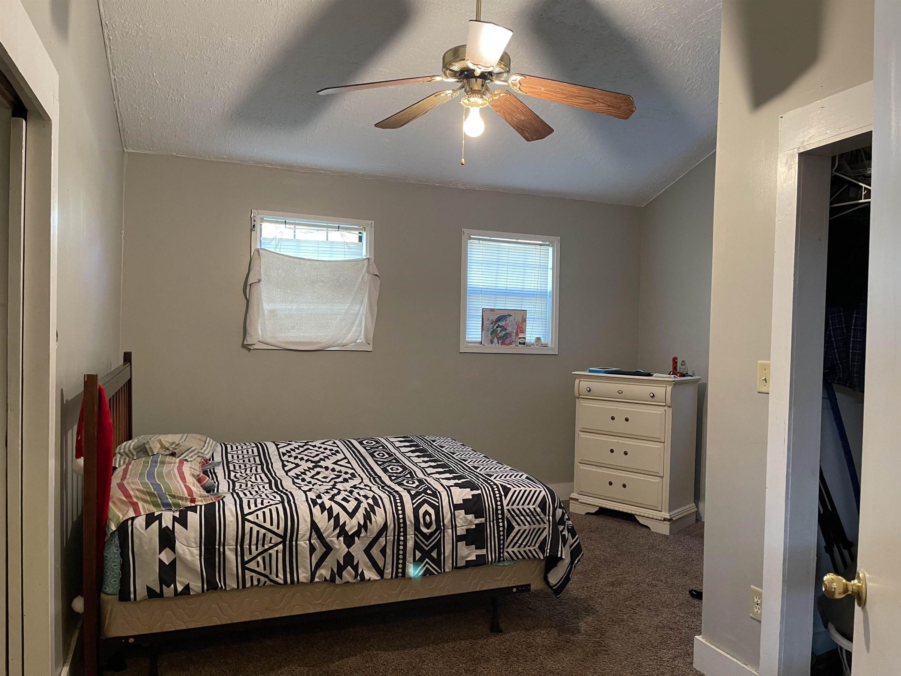 195 Old Denmark Road Jackson, TN 38301 - Photo 5 of 10 a bedroom with a bed and a chandelier