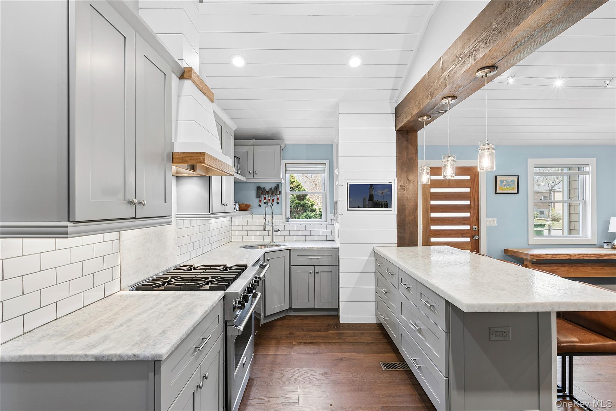 24 Woodridge Road Hampton Bays, NY 11946 - Photo 6 of 18 a kitchen with a stove a sink and a refrigerator