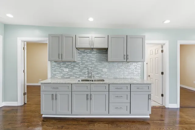 a kitchen with stainless steel appliances granite countertop a sink and cabinets