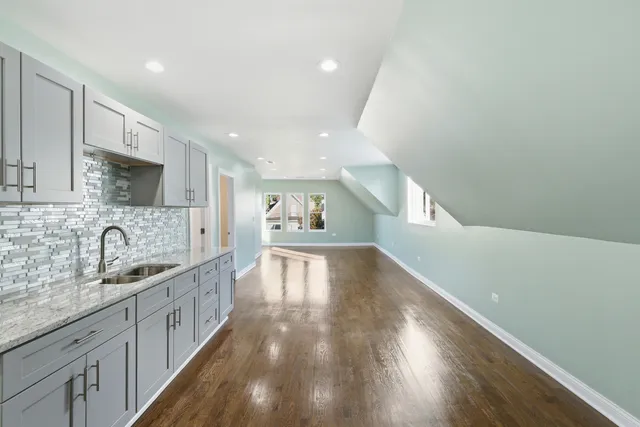 a kitchen with granite countertop a sink and cabinets