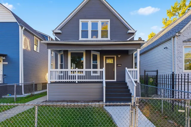 a view of a house with wooden deck and a yard