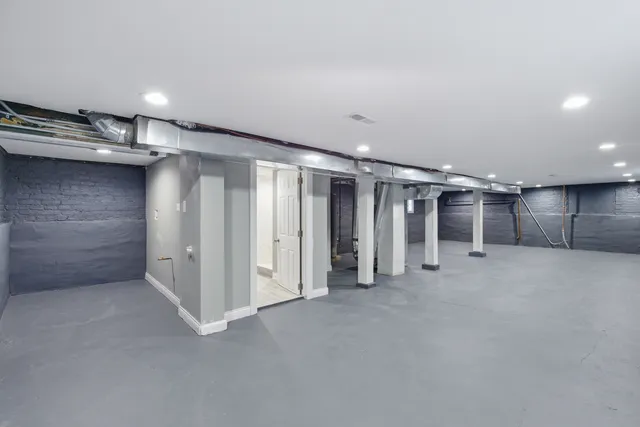 a bathroom with a toilet a sink and a window