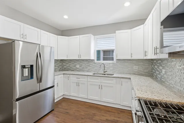 a kitchen with stainless steel appliances granite countertop a refrigerator sink and cabinets