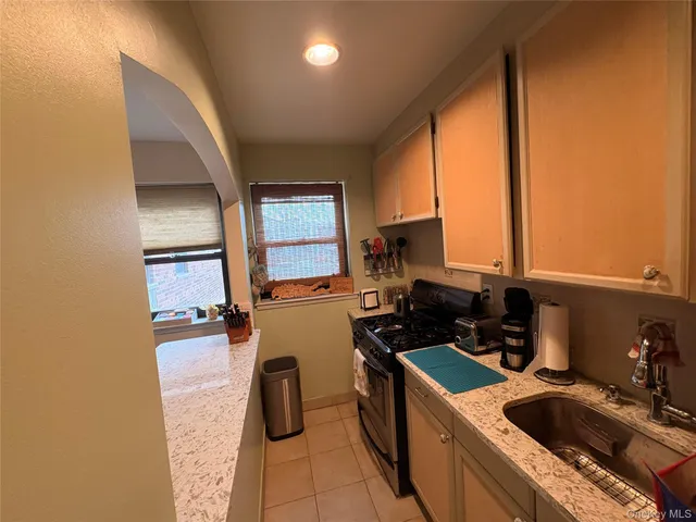 a kitchen with a sink a stove and a refrigerator