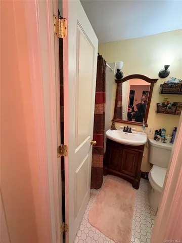 a room with sink and mirror