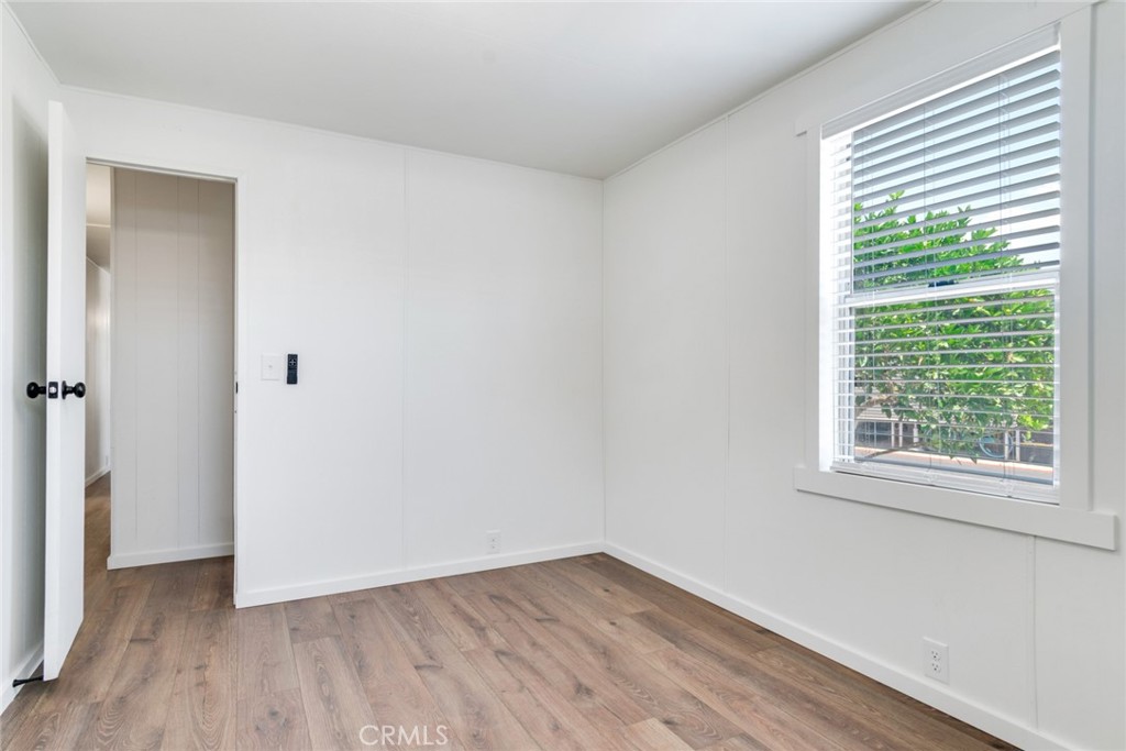 975 California Street, Unit 72 Calimesa, CA 92320 - Photo 18 of 23 an empty room with wooden floor and a window
