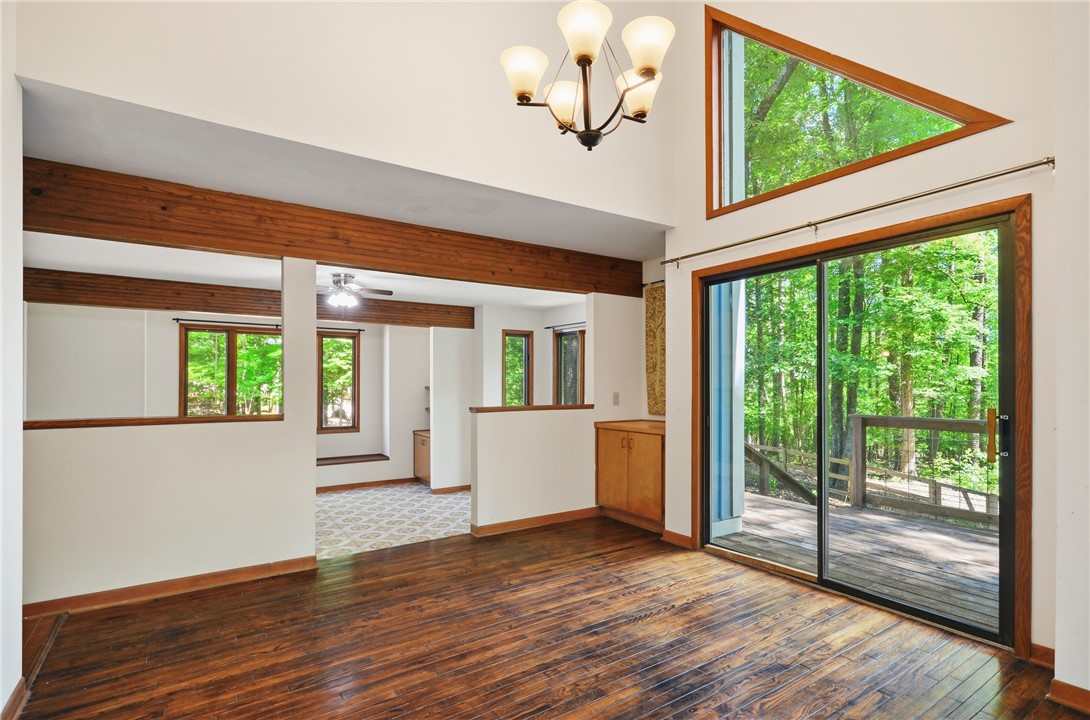 1298 Carradine Road Seneca, SC 29678 - Photo 19 of 43 A spacious, naturally illuminated room features gleaming hardwood floors and direct access to an outdoor deck.