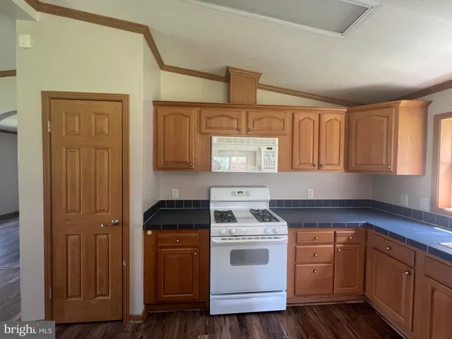 a kitchen with sink a stove and cabinets