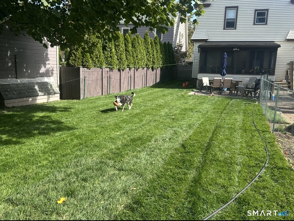 30 Coram Street Hamden, CT 06517 - Photo 21 of 38 Rear yard with newly-installed sod. Also shows stone patio and rear screened porch.