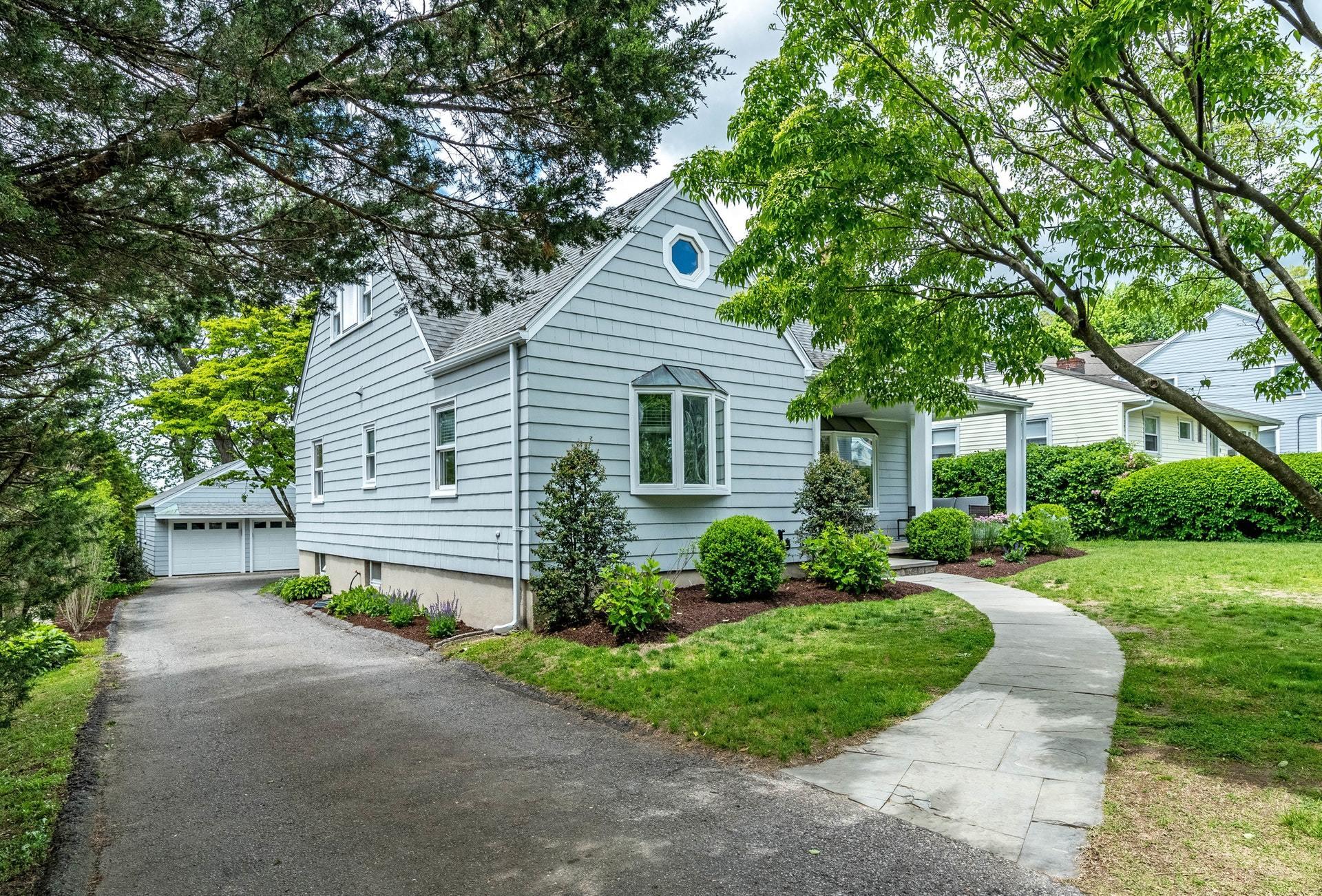 34 Ridgeley Street Darien, CT 06820 - Photo 3 of 26 a view of a house with a yard and table and chairs under an umbrella