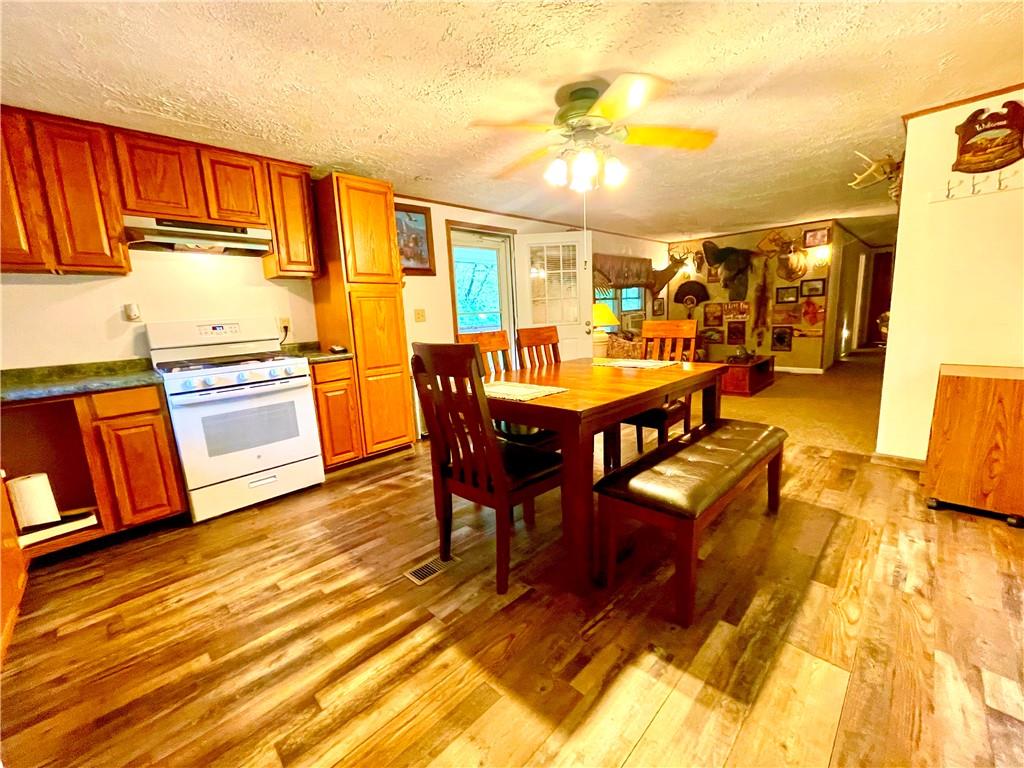 474 Iron Rock Road Waynesburg, PA 15370 - Photo 2 of 15 a view of a dining room with furniture and wooden floor