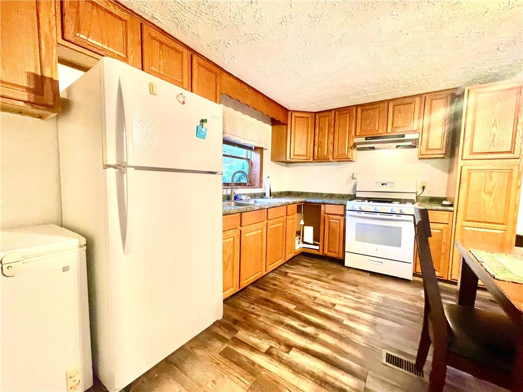 474 Iron Rock Road Waynesburg, PA 15370 - Photo 3 of 15 a kitchen with a sink a stove a refrigerator and a microwave