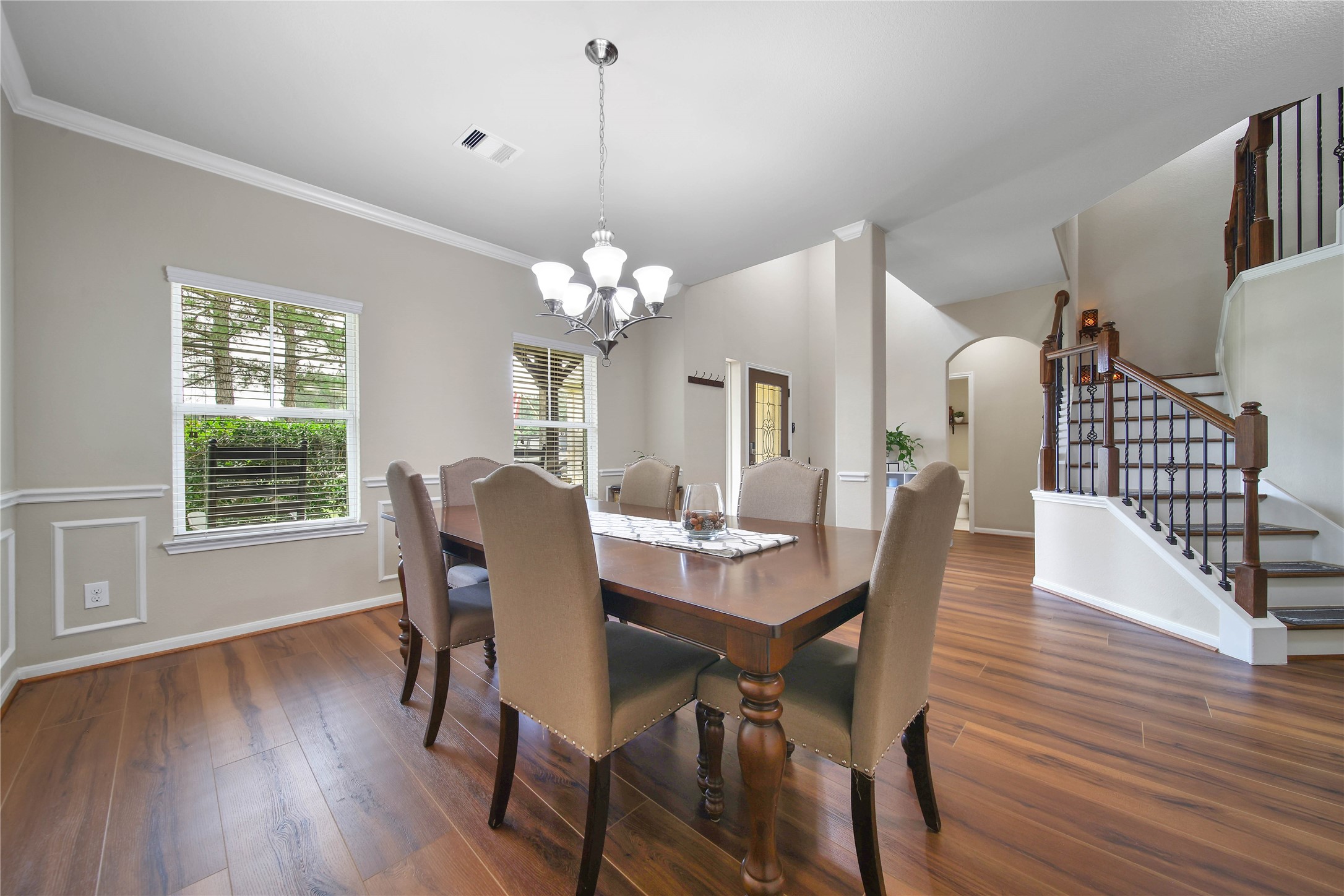 9223 Wapiti Trail Conroe, TX 77303 - Photo 11 of 45 a view of a dining room with furniture a chandelier and wooden floor