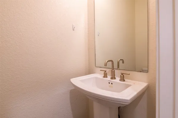 a white sink sitting under a bathroom