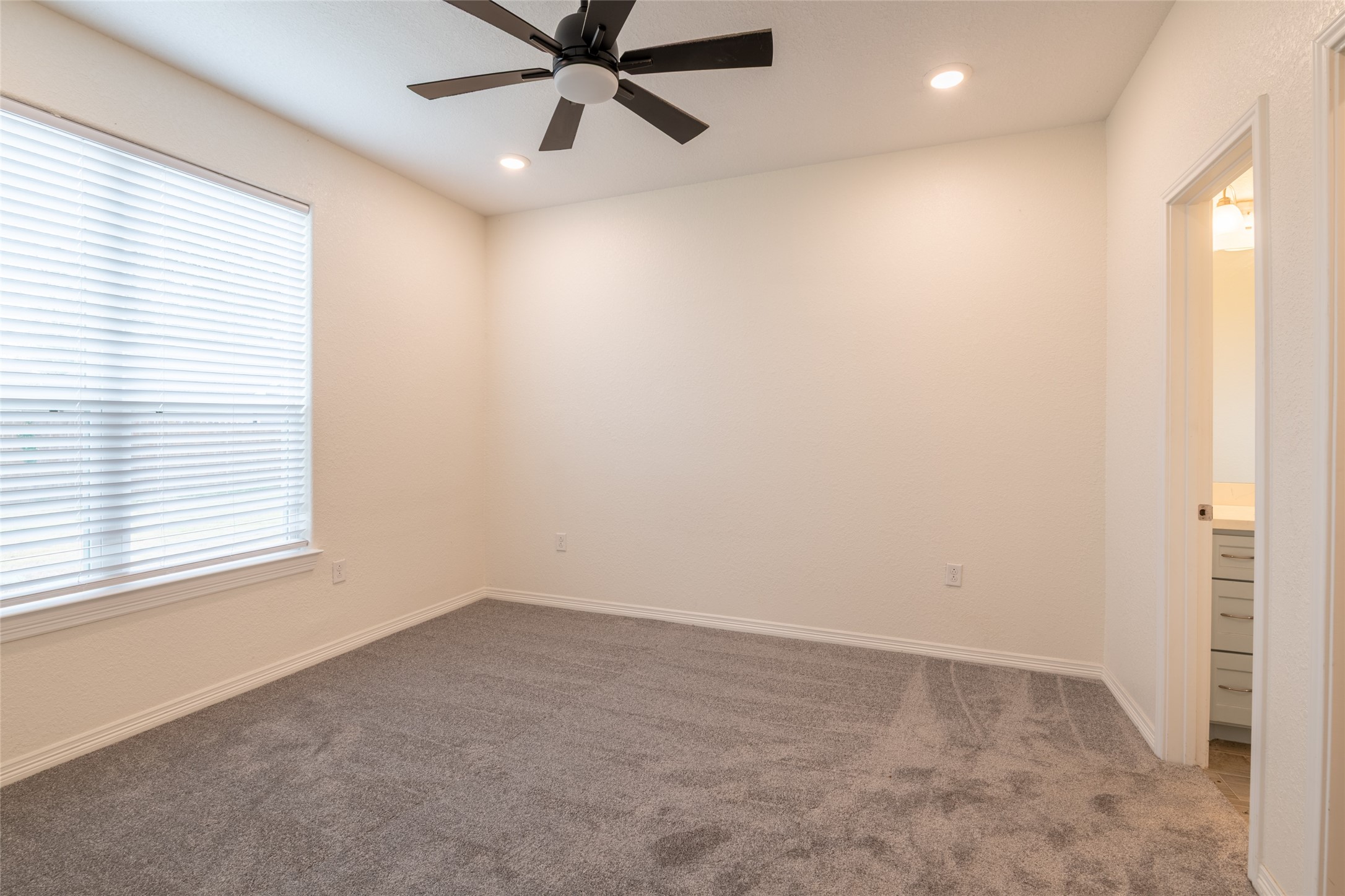 25012 Armagh Road Hempstead, TX 77445 - Photo 15 of 33 an empty room with a window and a fan