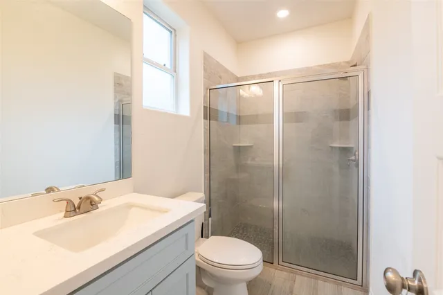 a bathroom with a sink toilet and shower