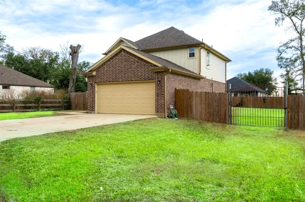 a front view of house with a garden