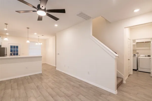 a view of a hallway with a kitchen