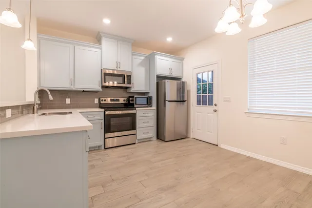 a kitchen with a sink stainless steel appliances and cabinets